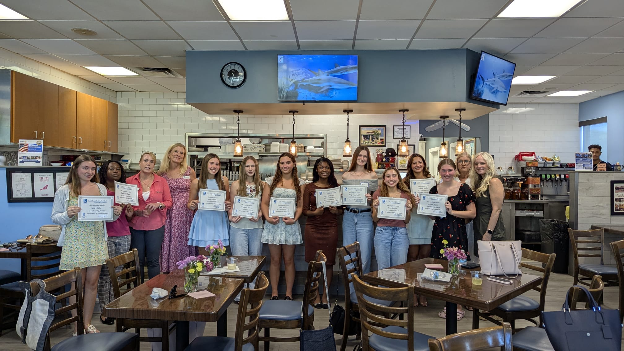 Scholarship recipients with their certificates